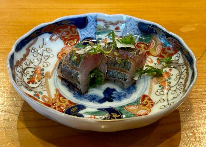 A delicate serving of sushi at Koban Sushi in the Fukushima Prefecture, served in a colorful bowl.